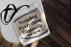 White canvas tote bag with "Avoiding Everything Elegantly" print and black strap