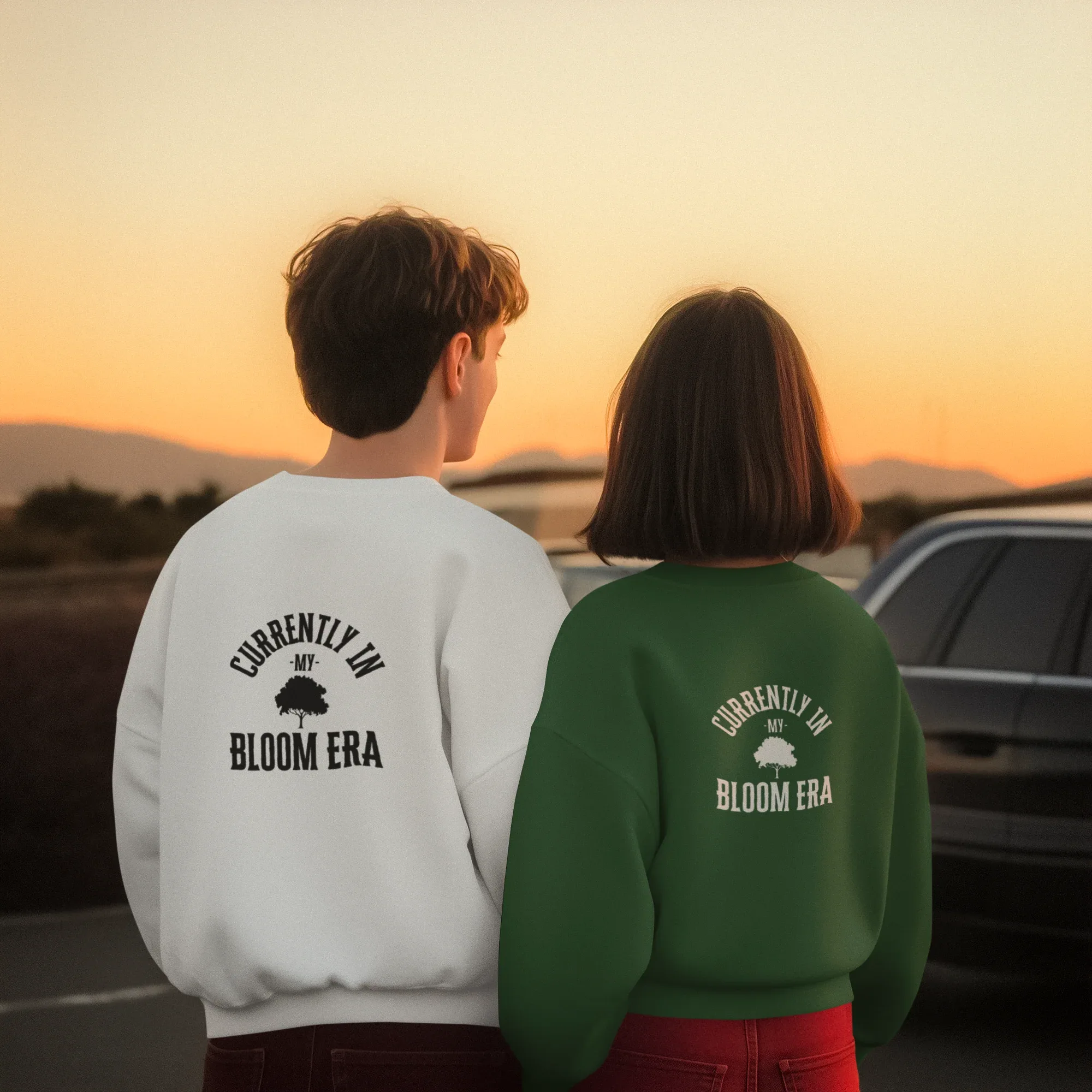 Pair of sweatshirts: white and forest green, each with "Bloom Era" back text print