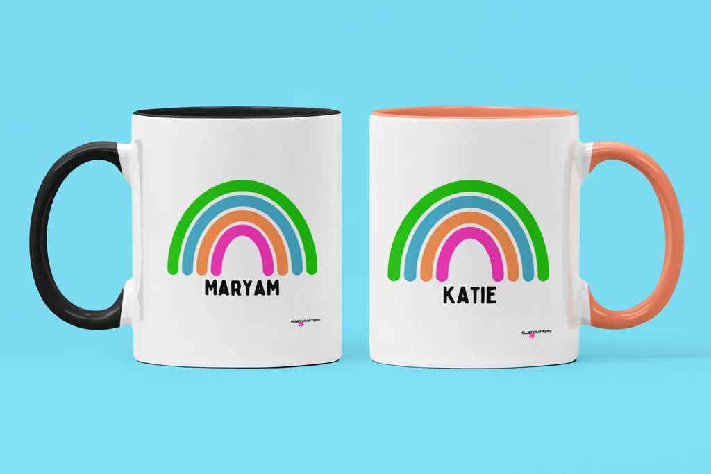 Personalised rainbow mugs set: MARYAM with black handle, KATIE with orange handle, rainbow names