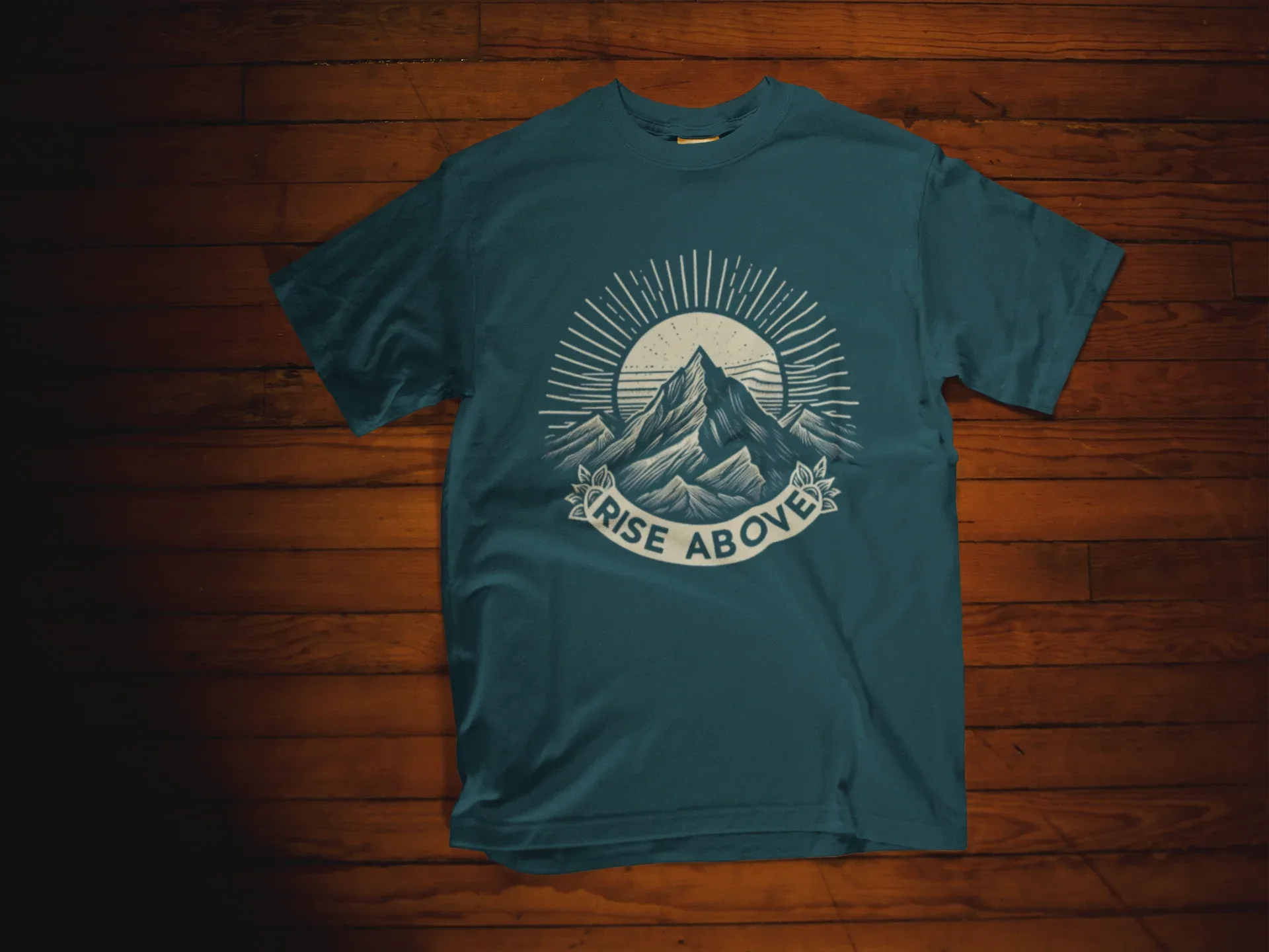 Teal short-sleeve T-shirt with mountain sunrise “RISE ABOVE” graphic
