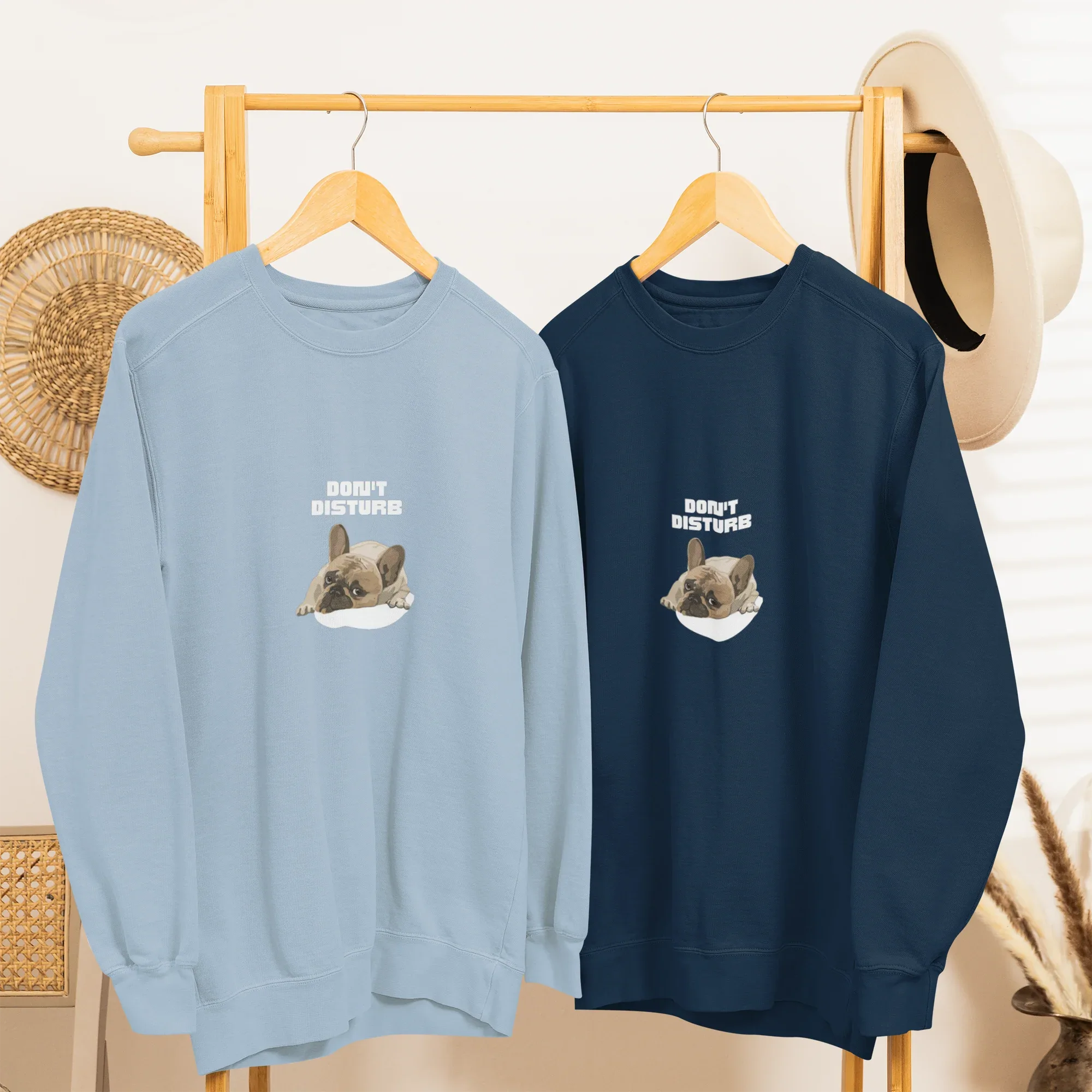 Light blue and deep navy sweatshirts with “DON’T DISTURB” text and sleeping French Bulldog graphic.