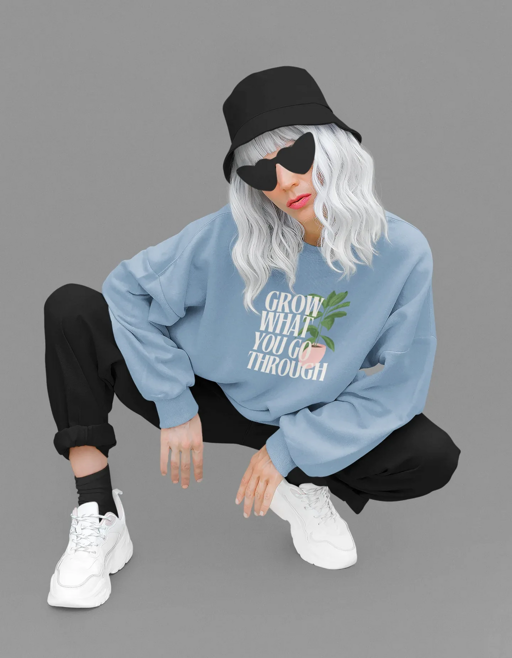 Light blue sweatshirt with “Grow What You Go Through” text and leaf graphic