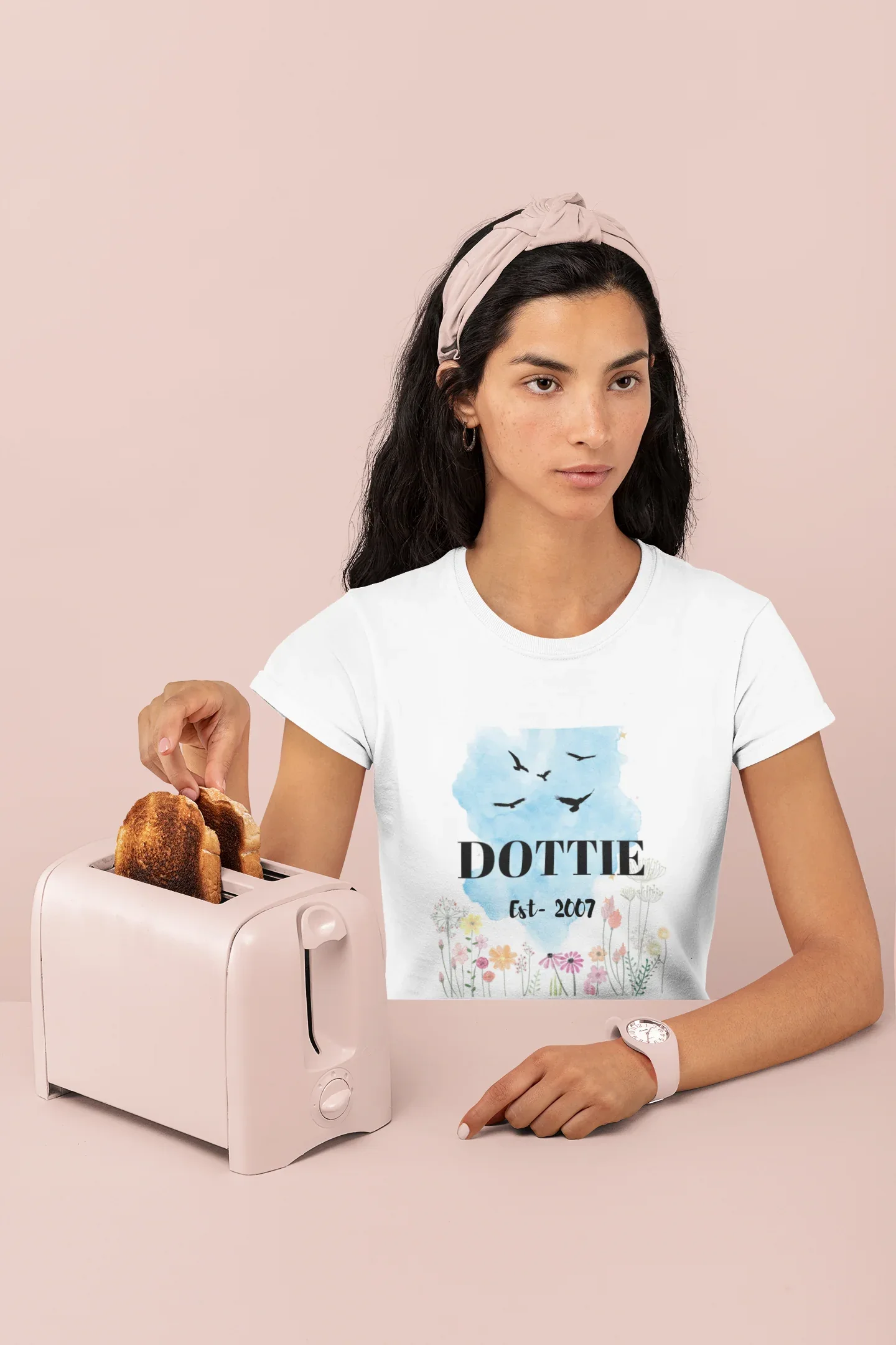 White unisex T-shirt on model, blue birds and floral name/year print.