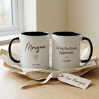 Morgan EST. 1994 black mug with Living the dream. Apparently. quote and gift-wrapped styling