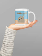 Dog graphic ceramic mug with blue “JUST LIVING” design and white handle