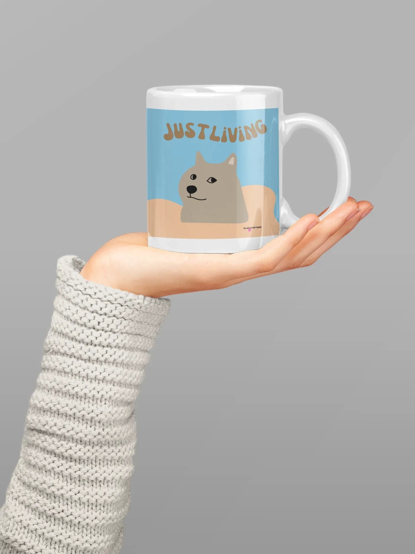 Dog graphic ceramic mug with blue “JUST LIVING” design and white handle