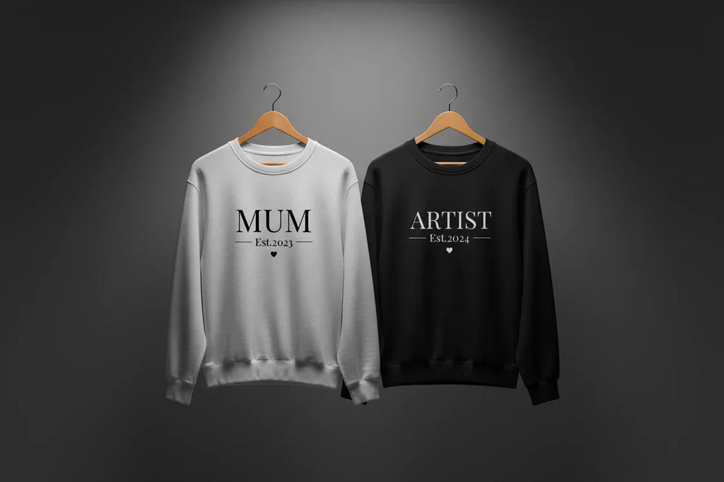 Light gray and black sweatshirts with MUM and ARTIST text, crew neck
