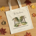 White canvas tote bag with personalized script name and watercolor woodland path print