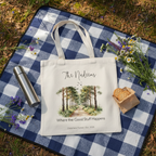 Cream canvas tote bag with illustrated forest path scene and cursive family name.