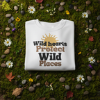 White sweatshirt with beige and black Wild hearts protect graphic, crew neck