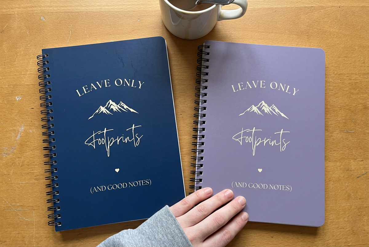 A5 hiking notebooks with navy and lavender covers, spiral binding, lined pages