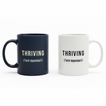 Navy and white THRIVING mugs angled with handles