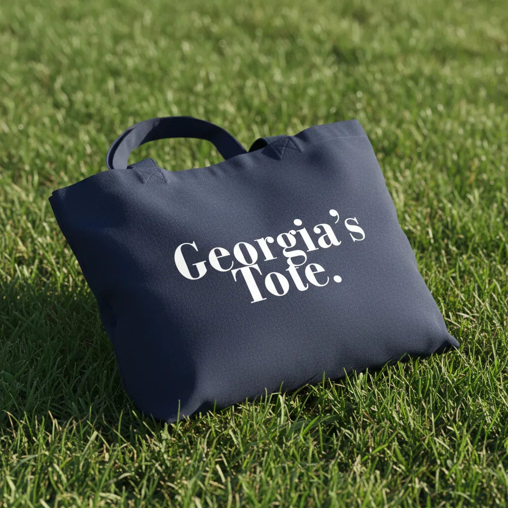 Navy cotton tote bag with custom text reading “Georgia's Tote.”