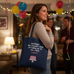 Navy tote bag with birthday quote and pink cake graphic, carried at a party