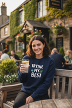 Navy sweatshirt with “TRYING MY BEST” quote print and green heart detail.