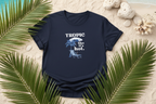Navy Tropic Like It's Hot T-shirt with blue palm tree and chair graphic on front