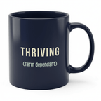 Dark ceramic mug with “THRIVING (Term dependant)” text on the front and handle.