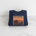 Navy crewneck sweatshirt with mountain sunset graphic and banner-style text