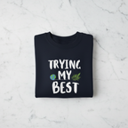 Navy sweatshirt with 'TRYING MY BEST' text and globe with leaves graphic