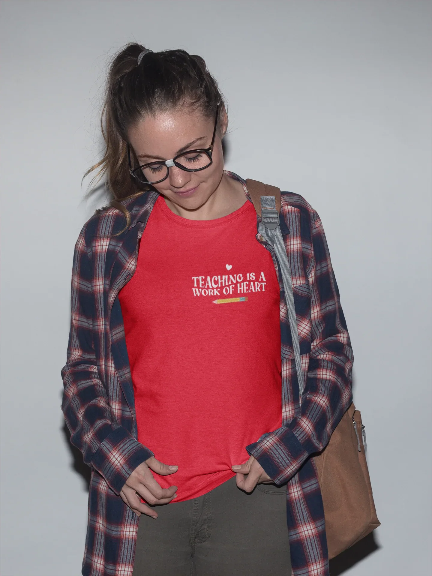 Red unisex T-shirt with crew neck and “Teaching is a Work of Heart” chest print