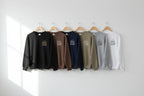 Crewneck sweatshirts on hangers in black, brown, navy, olive, gray, and white