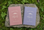 Two A5 hiking notebooks with pink and purple covers, spiral binding, lined pages