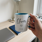 Oliver EST. 1987 blue mug held during a home-office tea break