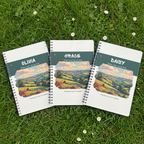 Olivia, Grace and Daisy personalised notebooks together on garden grass