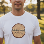 White crew-neck T-shirt with circular tree-ring badge graphic reading 'Seasoned'
