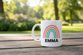 Personalised rainbow mug with EMMA name, white body and pastel rainbow graphic