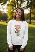 White crewneck sweatshirt on model featuring colorful “Take a Deep Breath” floral graphic.