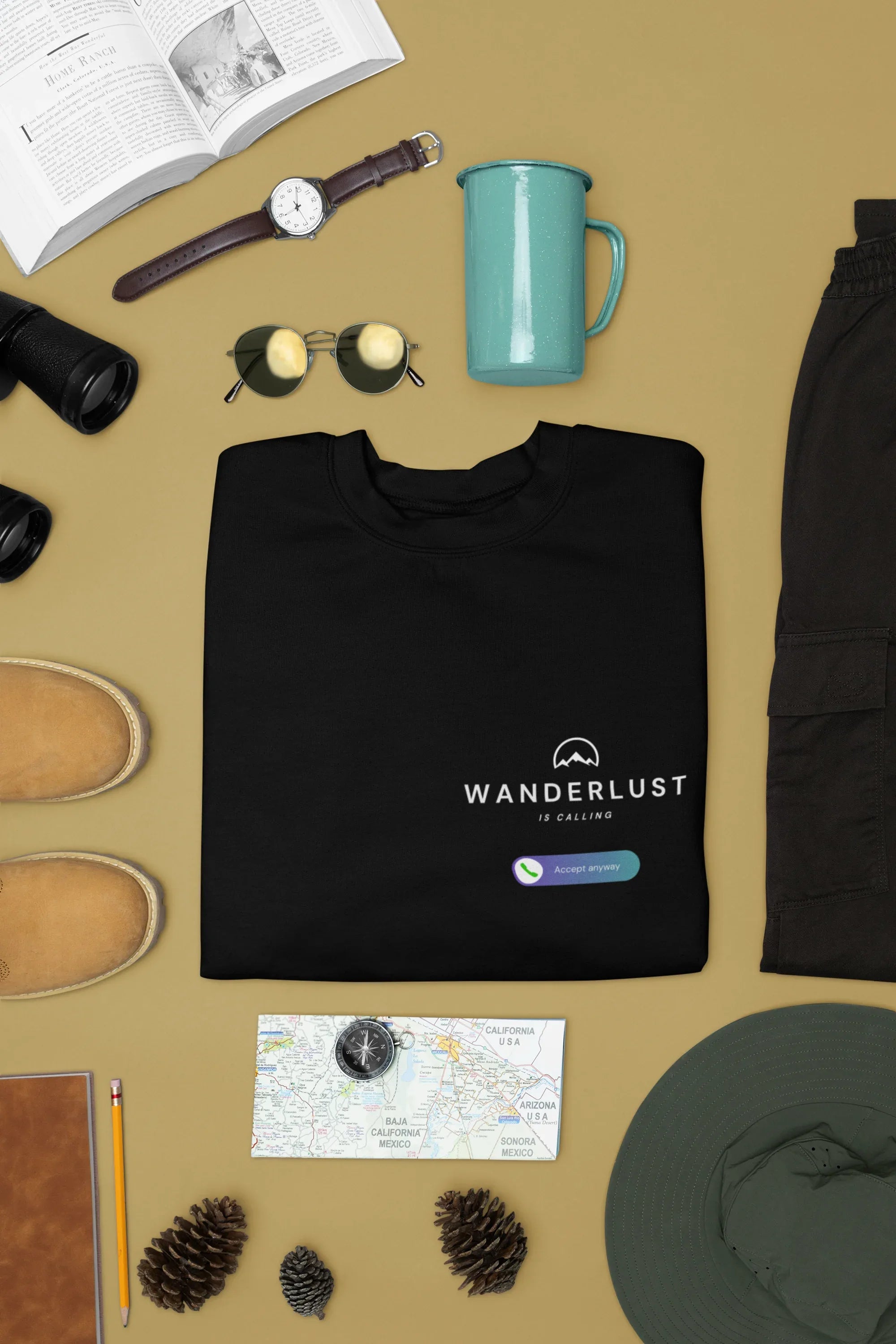 Black crewneck sweatshirt with Wanderlust is calling graphic and small logo patch