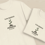 Light cream crew-neck T-shirts with “Slow Progress” plant graphic on front