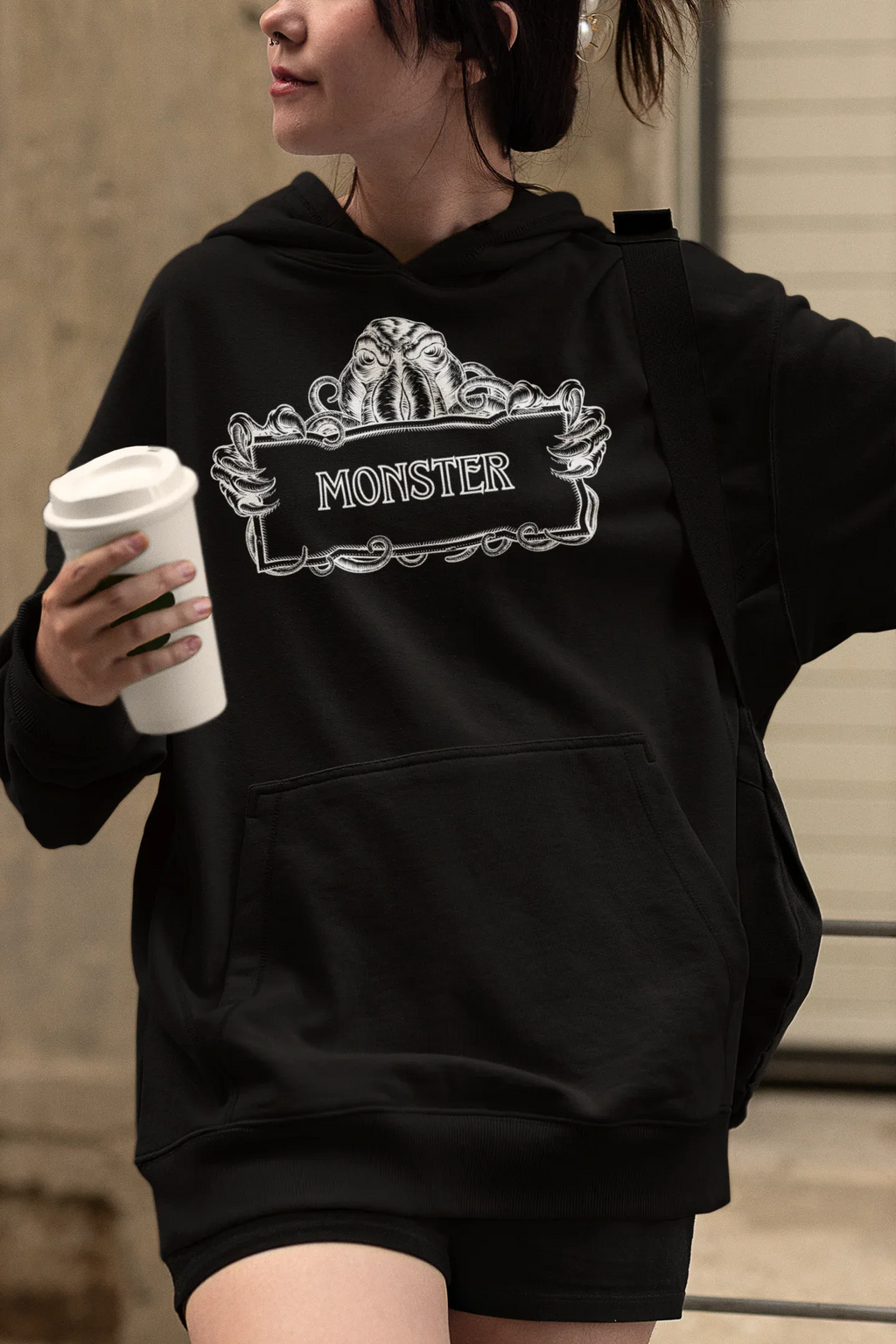 Black Monster Hooded Sweatshirt worn, side view showing white monster logo