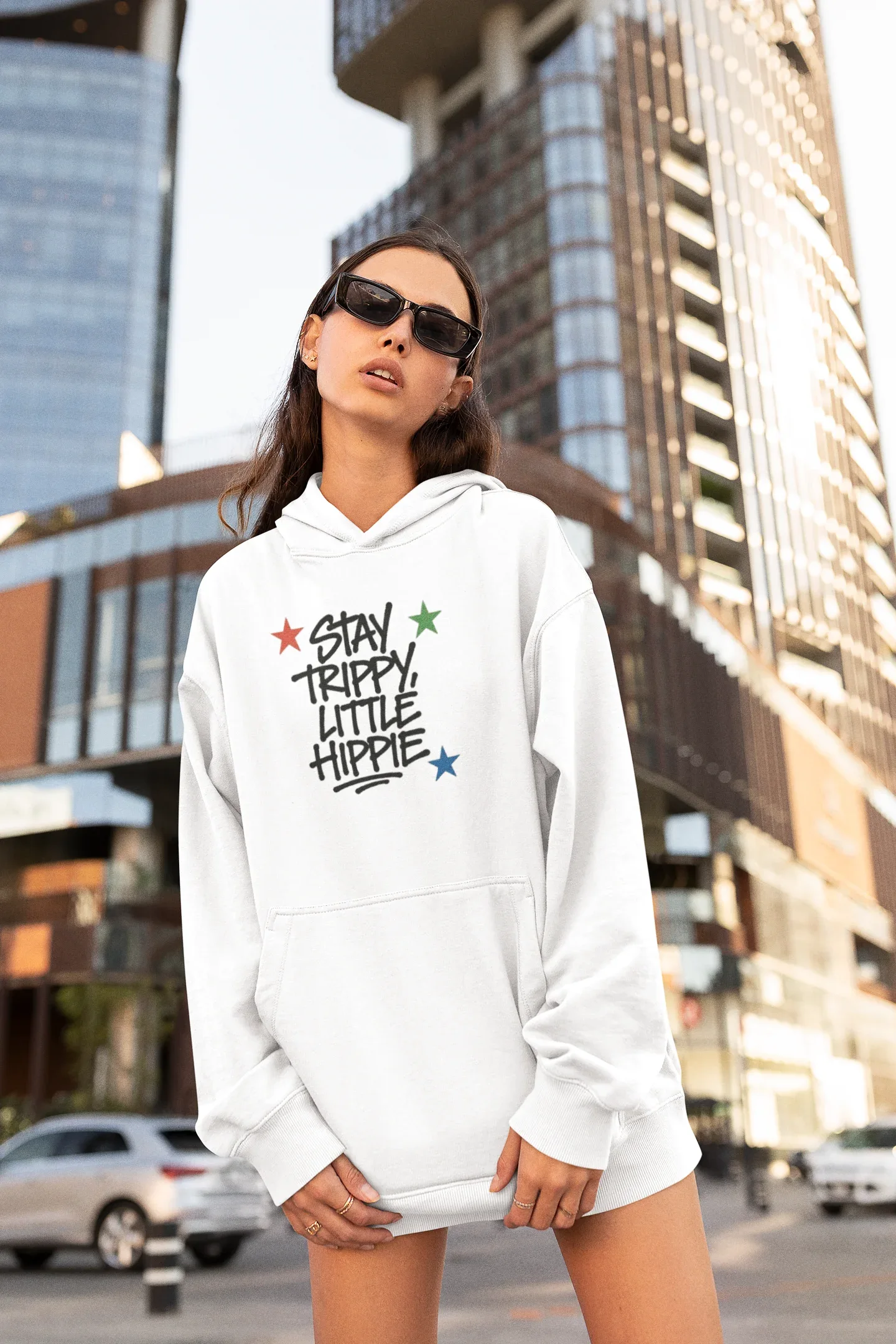 White pullover hoodie with front "Stay Trippy Little Hippie" star text graphic