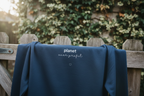 Oxford navy sweatshirt, back view close-up with planet logo and heart