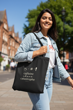 Black tote bag with white "caffeine chaos catastrophe" print