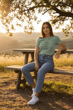 Teal crew-neck T-shirt with “GOOD ENERGY ONLY” print on the chest, worn by model