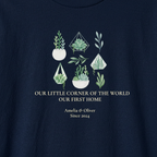 Navy t-shirt close-up with green botanical house design and “Our First Home,” “Since 2024”