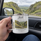 White enamel mug with silver rim, held in hand; 'Jack' name and route artwork
