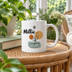 Personalized name mug in white ceramic with Millie and flower pot line art, angled view