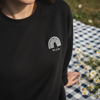 Black custom name sweatshirt with embroidered rainbow arch logo: mia