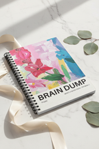 A5 spiral notebook with multicolor floral “BRAIN DUMP” cover on marble