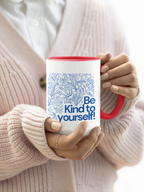 Red accent coffee mug with blue floral line art and 'Be Kind to yourself!' text