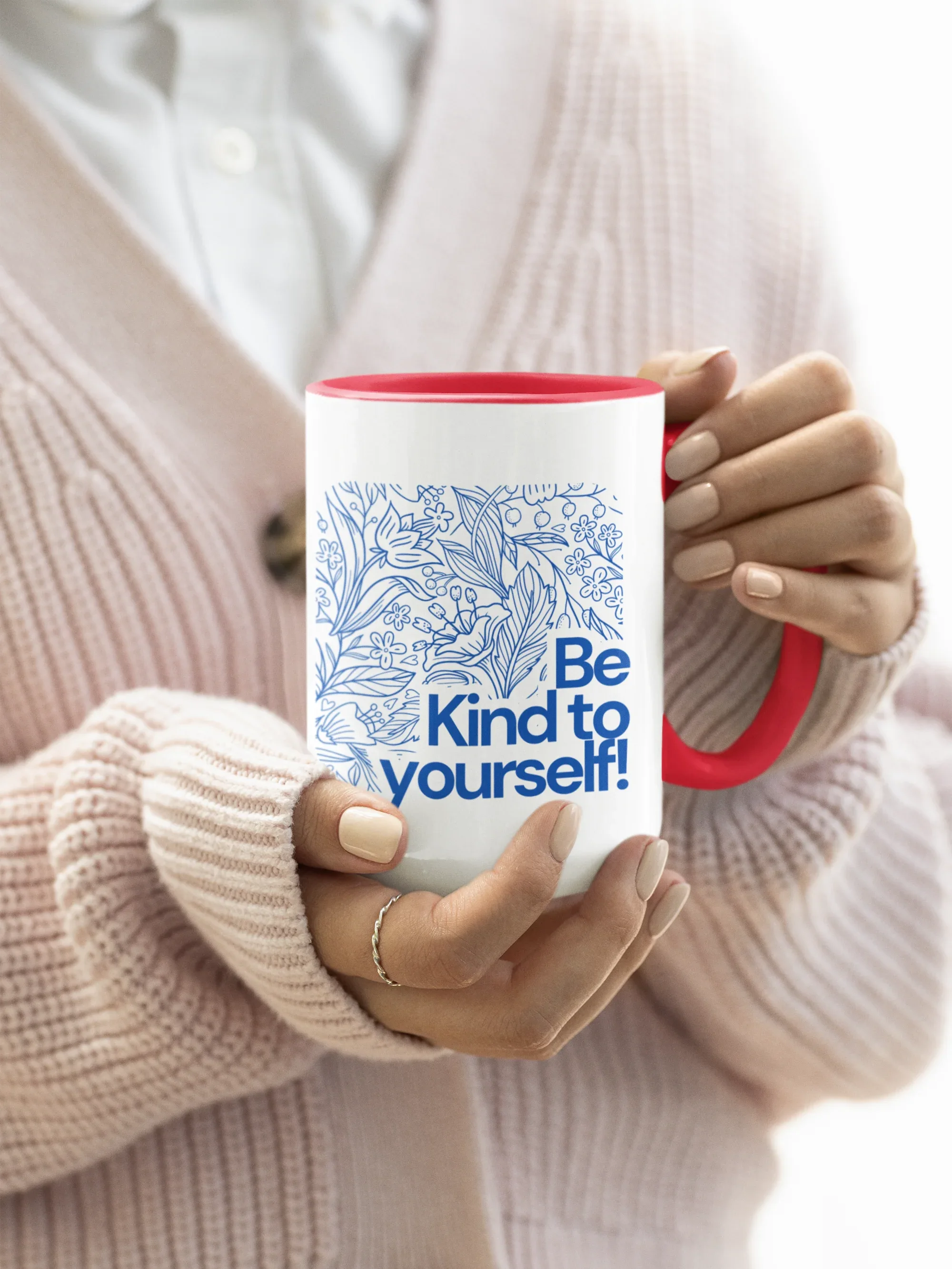 Red accent coffee mug with blue floral line art and 'Be Kind to yourself!' text