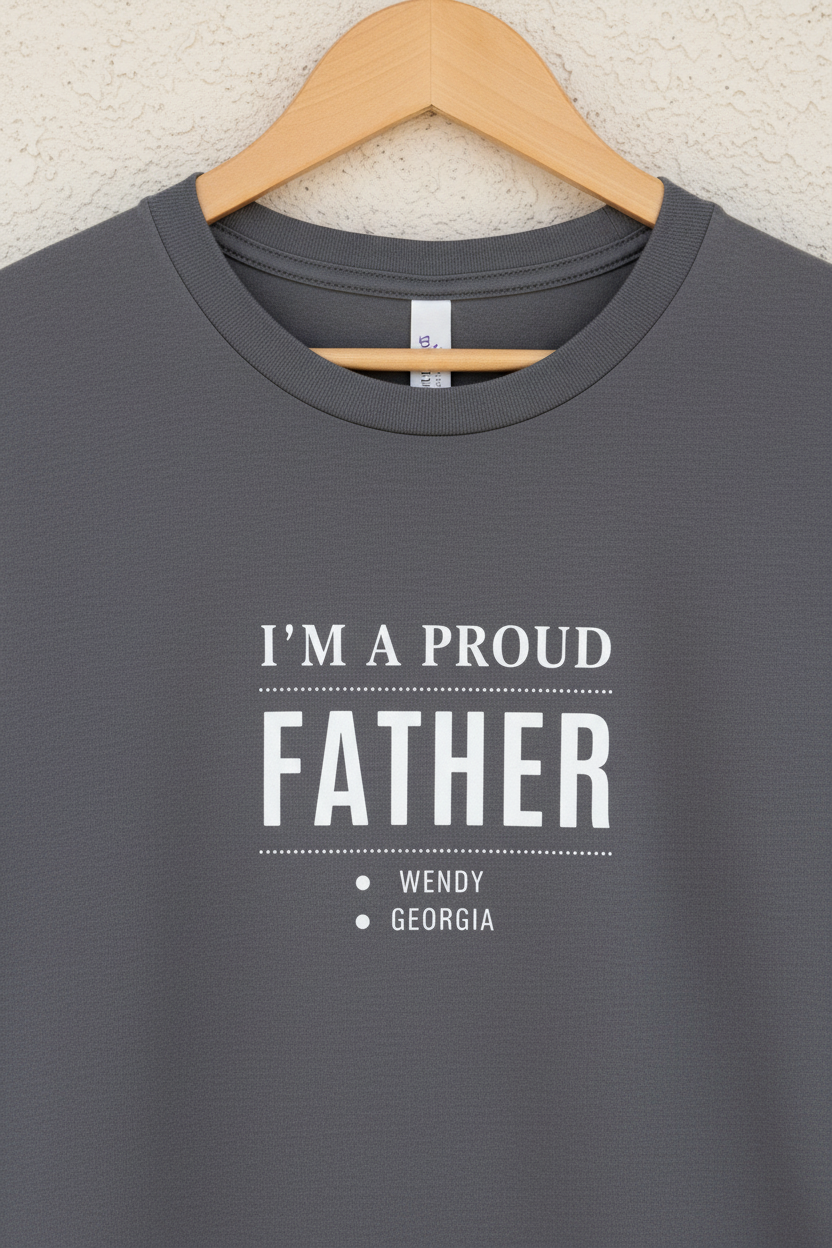 Charcoal T-shirt on hanger with "I'm a Proud Father" and names WENDY, GEORGIA