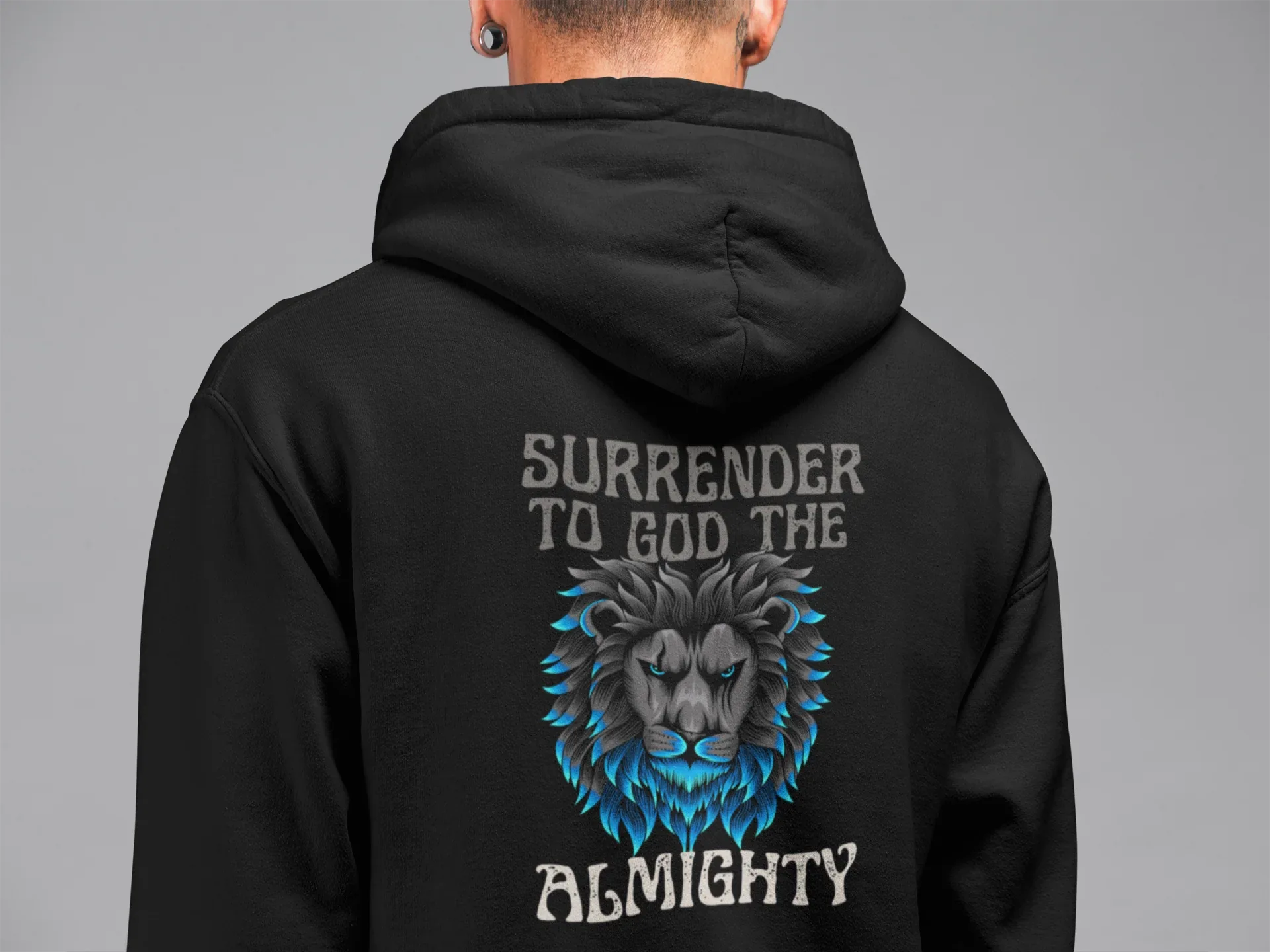 Black unisex hoodie, close-up of back lion graphic with 'Surrender to God the Almighty'