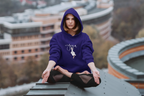 Purple hoodie with duck pose graphic, hood, and front pocket