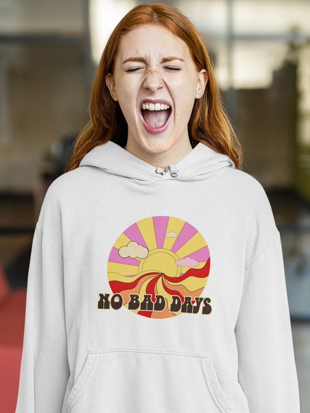 Light gray unisex hooded sweatshirt with colorful sun graphic on chest