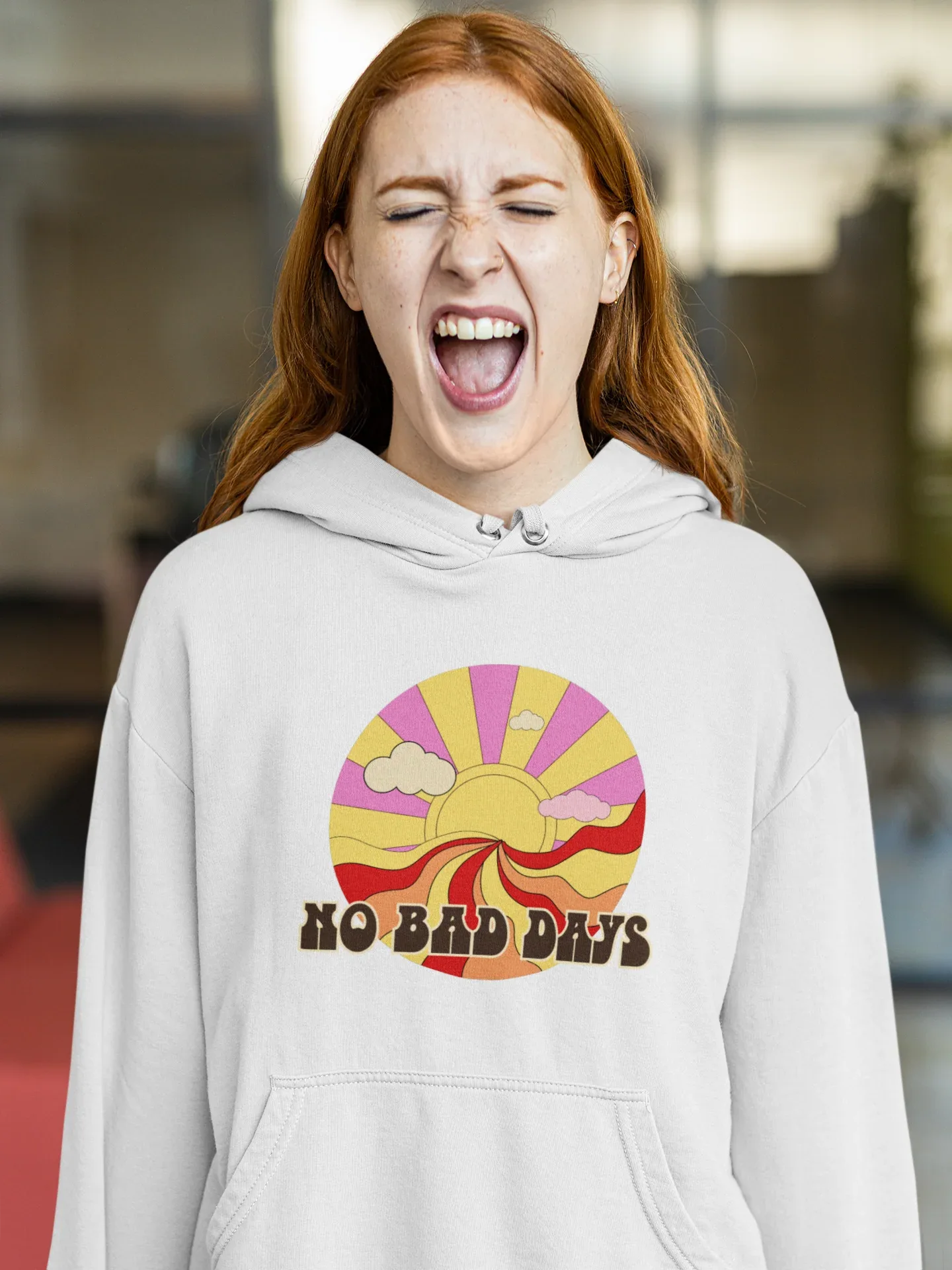 Light gray unisex hooded sweatshirt with colorful sun graphic on chest